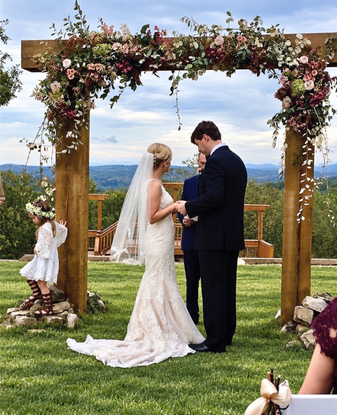 Wedding ceremony beneath a floral arch at Garland Mountain