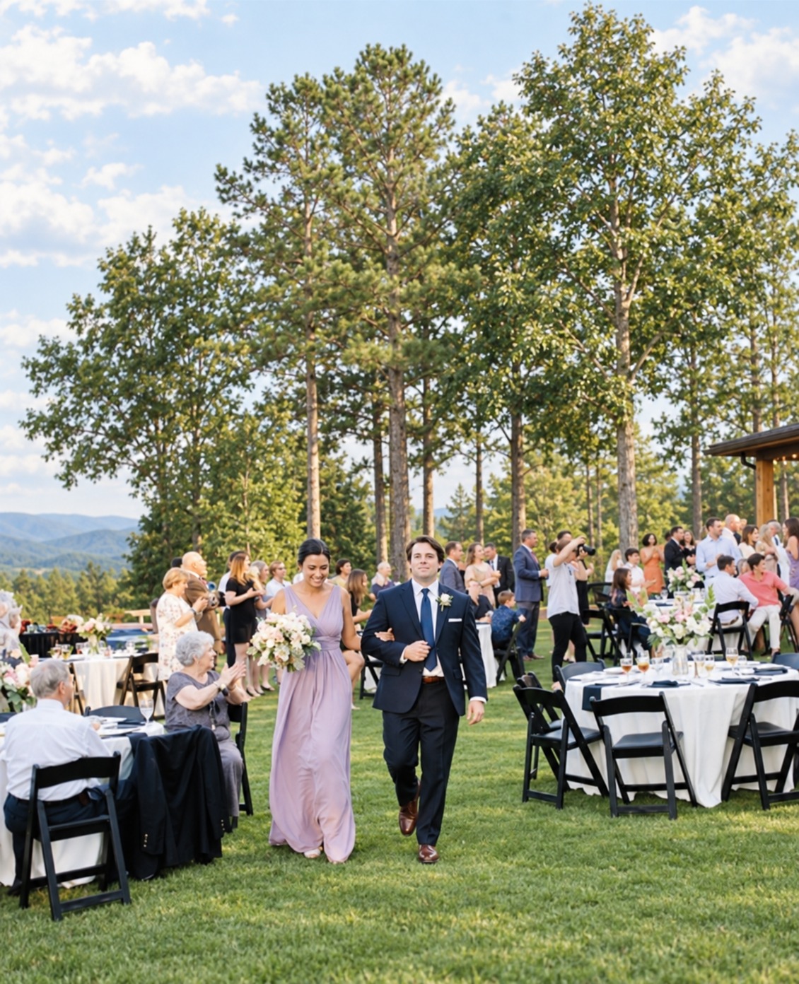 Wedding party walking between reception tables at Garland Mountain