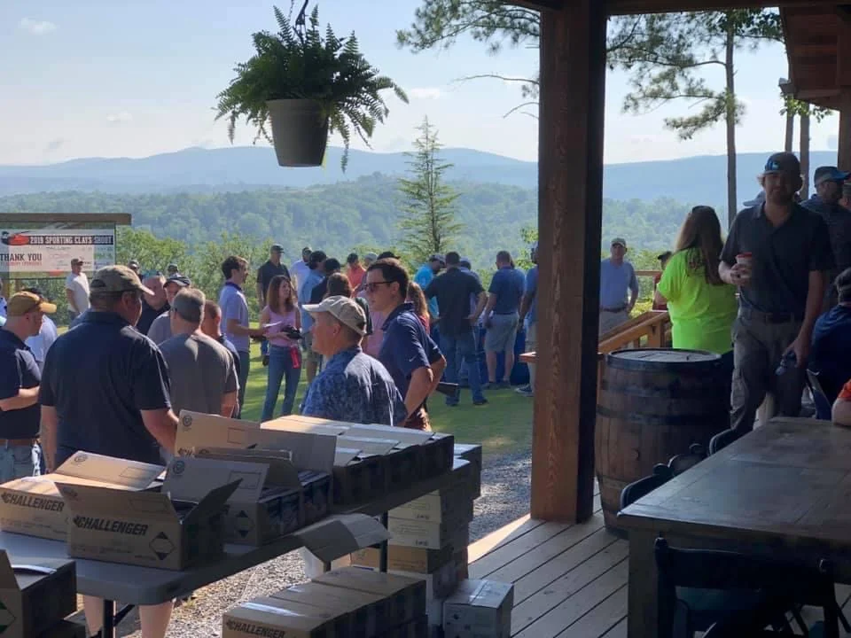 Guests gathering on the porch and lawn at Garland Mountain