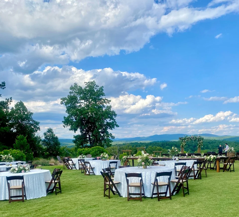 Tables set on the event lawn with a mountain view